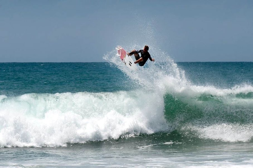 Surfer riding a wave at Arugam Bay